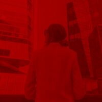 B2B marketing professional reviewing data strategy in a server room environment, representing Digital C4's approach to personalized content and lead generation